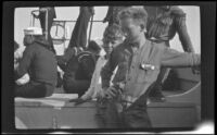 H. H. West Jr. stands on a boat with other Boy Scouts and sailors, San Pedro, 1931