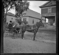 H. H. Cooper in a carriage parked in front of the West's home at 240 South Griffin Avenue, Los Angeles, (circa 1901?)