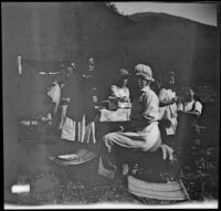 Frances, Elizabeth and Mary West and Kate, Irene and Chester Schmitz posing around their camp dining table, Warner Springs vicinity, about 1915