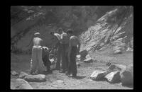 Boys Scouts tossing a scout into the pool at the bottom of Sturtevant Falls, San Gabriel Mountains, 1941