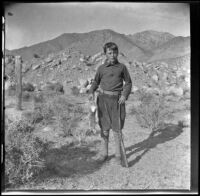 Wilfrid Cline holding the first rabbit that he had even killed at Ash Creek, Owens valley vicinity, about 1916