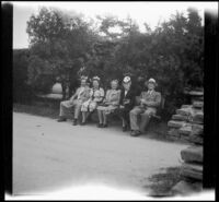 H. H. West, Jr., Anna West, Mrs. D. L. Tribe, Mertie West and D. L. Tribe sit on a bench at Knott's Berry Farm, Buena Park, 1947