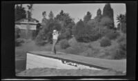 Glen Velzy drives a golf ball at the Raymond Hotel golf links, Pasadena, about 1919