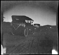 Cars traveling along a dirt road, Mendocino County vicinity, 1915