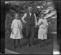 Frances and Elizabeth West stand on either side of their mother's uncle, Mr. Teel, Los Angeles, about 1915