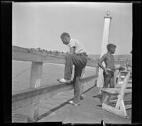 H. H. West Jr. fishes off of the San Clemente Pier, San Clemente, 1936