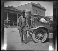 Harry Schmitz posing next to H. H. West's Buick, Red Bluff, 1917
