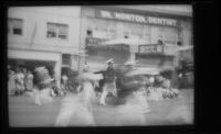 People marching in a parade with spectators in the background, Alhambra, 1937