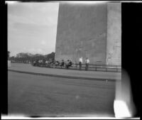 Mertie West seated at the base of the Washington Monument with other tourists, Washington, D.C., 1947