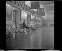 Mertie West and a caretaker sit in the trophy and relic room at Faneuil Hall, Boston, 1947