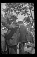 Man looks at a register at the Iowa Picnic in Bixby Park, Long Beach, 1938