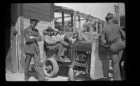 Soldiers sit on a small truck at the Southern Pacific Railroad depot, San Luis Obispo, 1942
