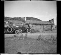 Dave F. Smith, Isabelle Smith, Nella West and Mary A. West visiting an old log cabin, Mammoth Lakes vicinity, 1913