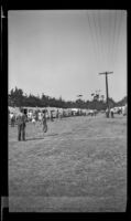 Boys stand near a race's finish line during a trailer rally in Seaside Park, Ventura, 1947