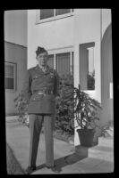 P.F.C. H. H. West, Jr. poses outside the West's residence while visiting on a 3-day pass, Los Angeles, 1944