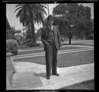 H. H. West stands in front of his house wearing his Shriners fez, Los Angeles, 1938