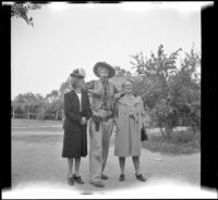 Mertie West and Mrs. D. L. Tribe pose with the Sheriff of Ghost City at Knott's Berry Farm, Buena Park, 1947