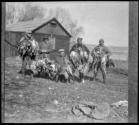 Members of the Alamo Gun Club pose with ducks outside their clubhouse, Gorman vicinity, circa 1910s