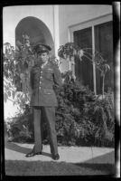 PFC H. H. West, Jr. stands in front of H. H. West's residence, Los Angeles, 1944