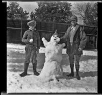 H. H. West, Jr. and Mertie West pose with a snowman, Redlands vicinity, about 1930