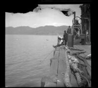 Port Los Angeles with two men on the pier and mountains in the distance, Santa Monica, about 1898