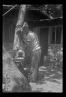 Glen Velzy filling the coal oil lamp, San Gabriel Mountains, 1941
