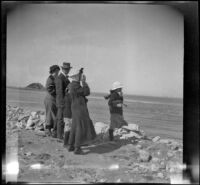 Bessie Velzy, Glen Velzy, Frances West, Mrs. George M. West and Elizabeth West stand on the shore and gaze towards the water, Los Angeles, about 1910