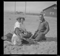 Elizabeth and Frances West on a blanket while Mary West leans her chin on Maude Hamilton's shoulder and Guy West sits beside them, Venice, about 1908