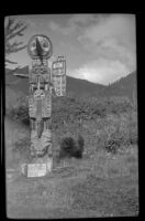 Sun and Raven totem pole standing at Saxman Totem Park, Saxman, 1946