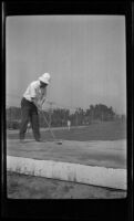 A man gets ready to drive a golf ball, Monterey vicinity, about 1920