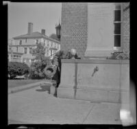 H. H. West drinks from Pilgrim Spring in front of the post office, Plymouth, 1947