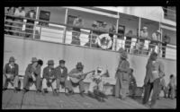 Filipino men playing guitar and banjo on the dock, Metlakatla, 1946