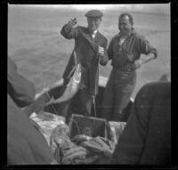 Charles Miles and Guy M. West catching fish off the coast, Santa Monica, about 1910