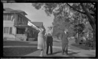 Ann West, Hebard West and Wayne West stand on the front lawn of Wayne West's home, Santa Ana, 1946