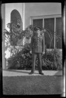 PFC H. H. West, Jr. poses in front of H. H. West's residence, Los Angeles, 1944