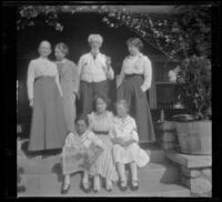 Members of the West and Cline families pose on the front porch steps of the West residence on South Harvard Boulevard, Los Angeles, about 1915