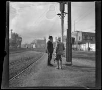 Alexander Campbell and "Old man" Smith wait for a train at Naud Junction, Los Angeles, 1900