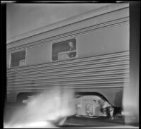 Mertie West looking out of window on Pullman car, Albuquerque, 1947