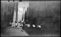 Mertie West stands along a street curb outside a Methodist church, New York, 1947