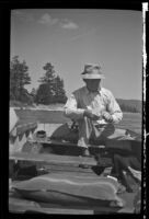 Forrest Whitaker rigging up his tackle, Big Bear Lake, 1943