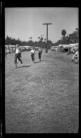 Boys race between rows of trailers during a trailer rally in Seaside Park, Ventura, 1947