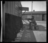 A fisherman mending his net by the station in San Pedro, Los Angeles, about 1898