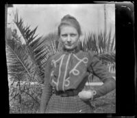 Louise Ambrose poses in front of palm fronds outside her family's home, Los Angeles, about 1894