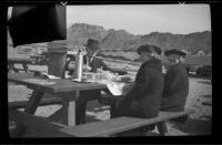 Wes Witherby, Mertie West and Zetta Witherby eat lunch on the shore of Lake Mead, Boulder City vicinity, 1939