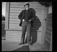 Minnie Kellum dons men's attire and poses on the front porch of her family's home, Los Angeles, about 1899