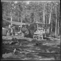 Mertie West, Agnes Whitaker, and Forrest Whitaker next to a temporary camping kitchen at Convict Lake, Mammoth Lakes vicinity, 1929