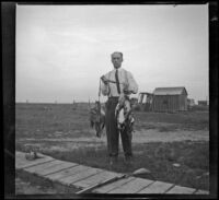 Carl Salbach poses with ducks killed during a hunt, Orange County vicinity, 1912