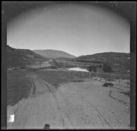 Crane Lake overflows onto a dirt road after a heavy storm, Gorman vicinity, circa 1910s