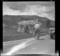 Sightseers pose for a photograph in front of the House of Antlers, Yellowstone National Park, 1942