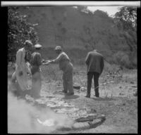 Game Warden Pritchard serves barbecue to attendees of the Rubber Men's Picnic, Santa Monica Canyon, about 1908